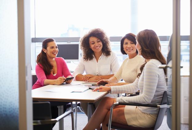 Visual featuring a group of wowen around a table