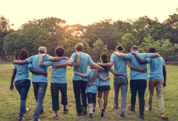 Visual for Social, featuring people walking while holding each others 