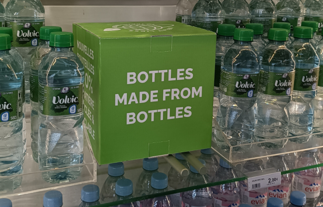 Bottles of water displayed along sign &quot;bottles made from bottles&quot;
